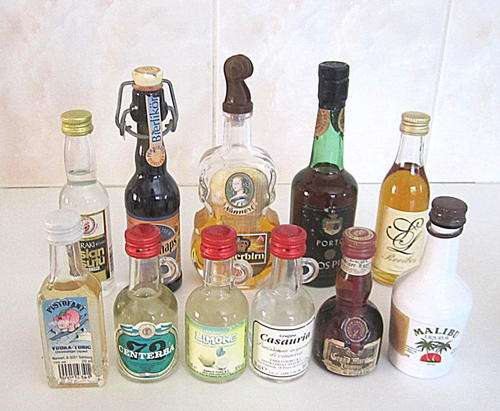 A LOT OF LIQUER BOTTLES MOSTLY SEALED