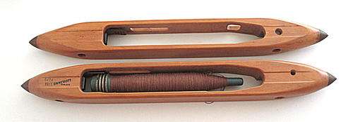 2  VINTAGE BANCROFT WEAVING SHUTTLES-- 1 HAS A BOBBIN AND COTTON