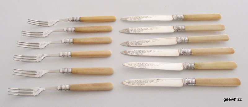 A SET OF SILVER PLATED EMBOSSED FRUIT KNIVES AND FORKS WITH IVORY HANDLES