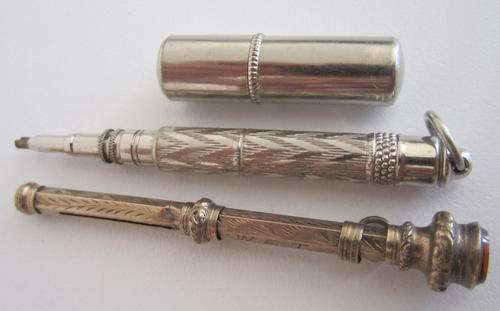 2 VINTAGE PROPELLING PENCILS AND A CONTAINER WITH LEADS