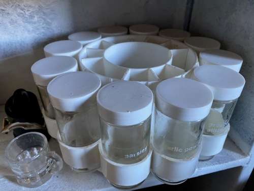 Revolving spice rack plus bottle stopper and glass tot measure