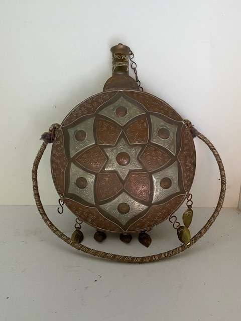 Beautiful ornately decorated brass wine container: Slight dent at the back