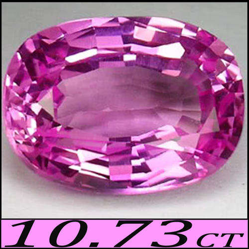 10.73 CT NATURAL UNHEATED BRAZILIAN PINK TOPAZ, A MODERN MODIFIED OVAL POLISHED GEMSTONE.