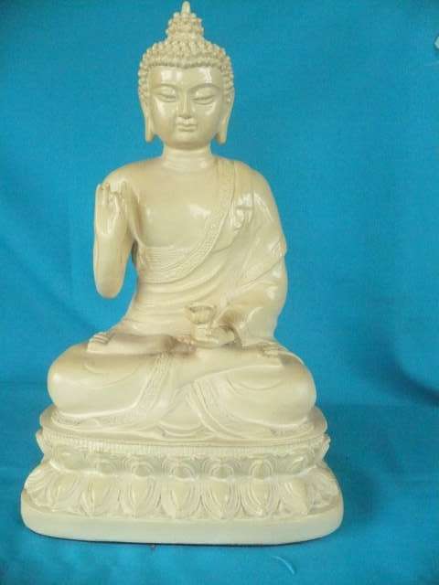 A MALAYSIAN DEITY SITTING ON A LOTUS FLOWER WITH A LOTUS IN HER HAND