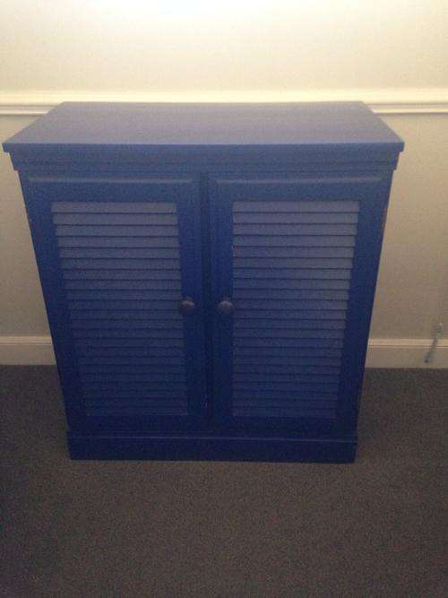 Wooden credenza with louvered doors