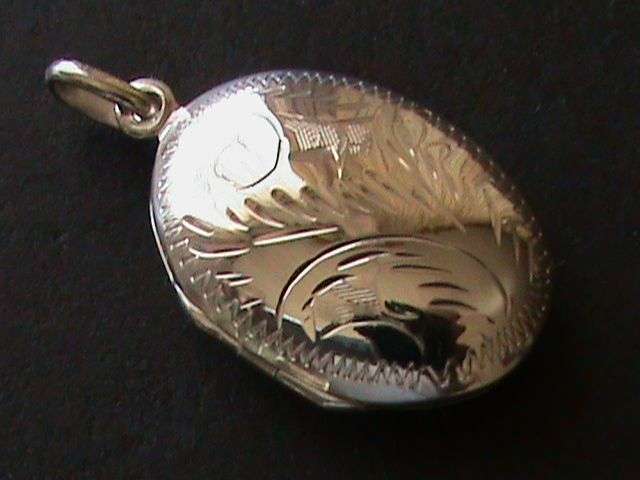 SOLID STERLING SILVER OVAL LOCKET..