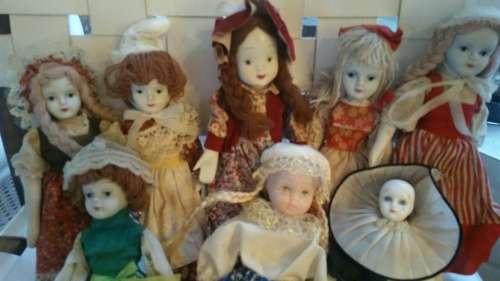 A Collection of 12 Vintage doll, 9 Porcelain and 3 Plastic