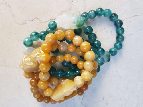 6 Jade Bracelets 3 green and 3 brown with Rabbit Motif, a symbol of longevity