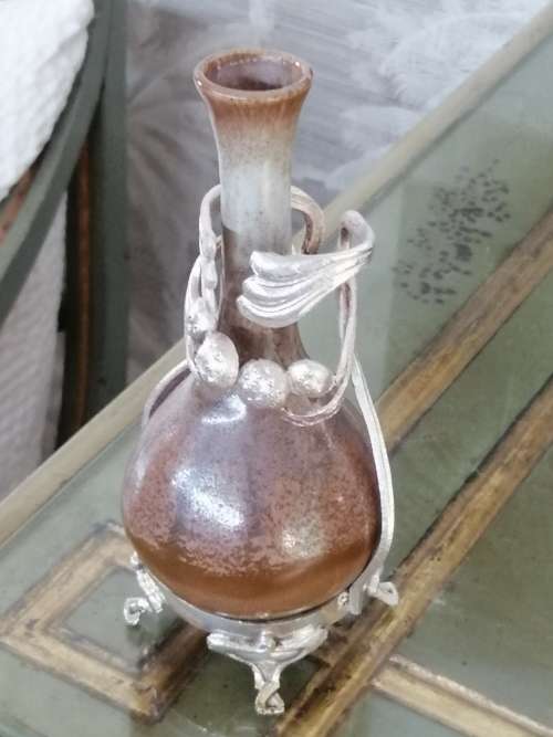 A LANCASTRIAN POTTERY BUD CASE IN AN EPNS HOLDER