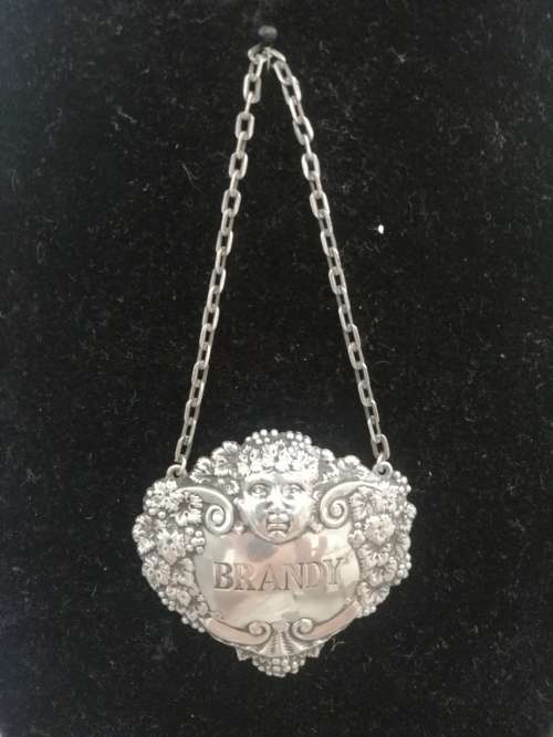 A HALLMARKED SILVER BRANDY DECANTER LABEL