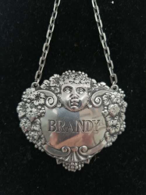 A HALLMARKED SILVER BRANDY DECANTER LABEL