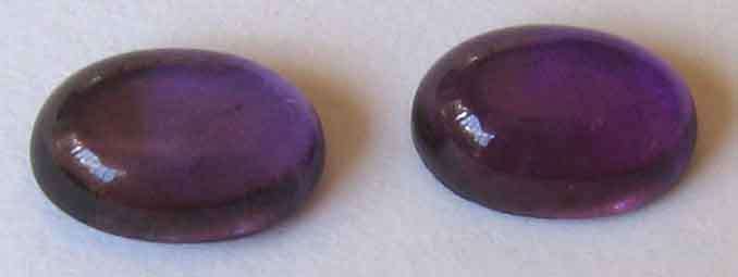 1lot, 2 pieces of  7.00 x 5.00 mm oval cabachon cut amethysts, T. W.  1.72 cts.