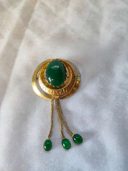Very interesting gold tone brooch with green stones