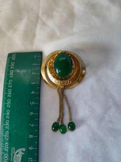 Very interesting gold tone brooch with green stones