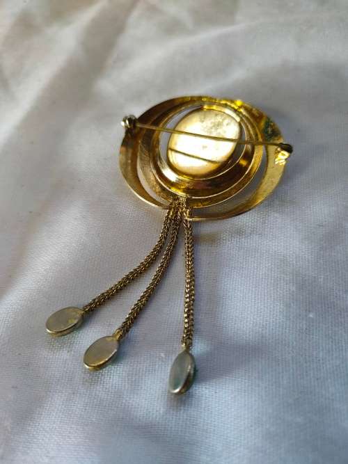 Very interesting gold tone brooch with green stones