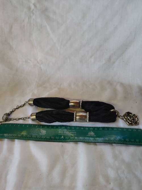 A stunning black scarf necklace with big rose pendant