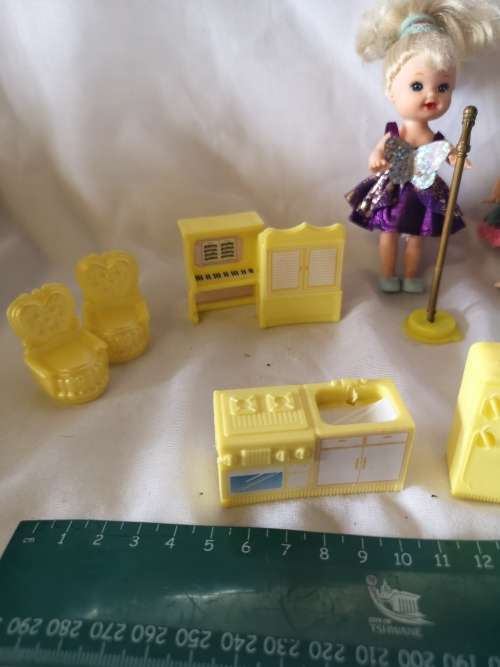 Two small Barbie's sister-like dolls with toy furniture.