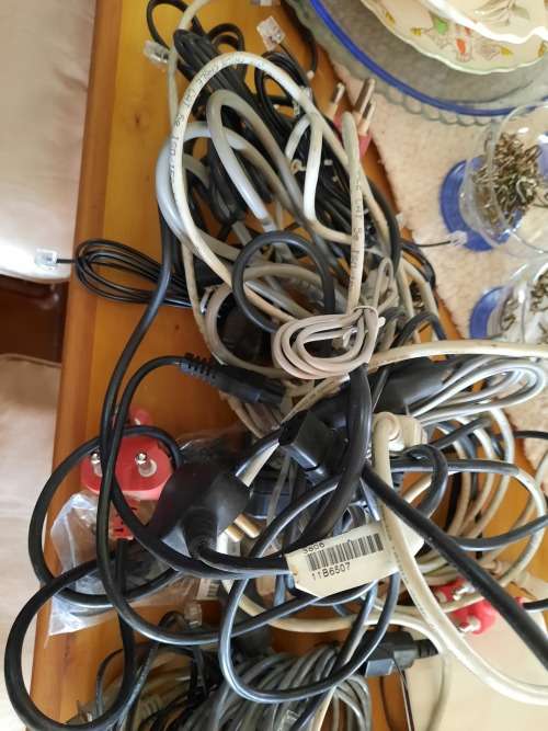 Box of computer cables and programme discs