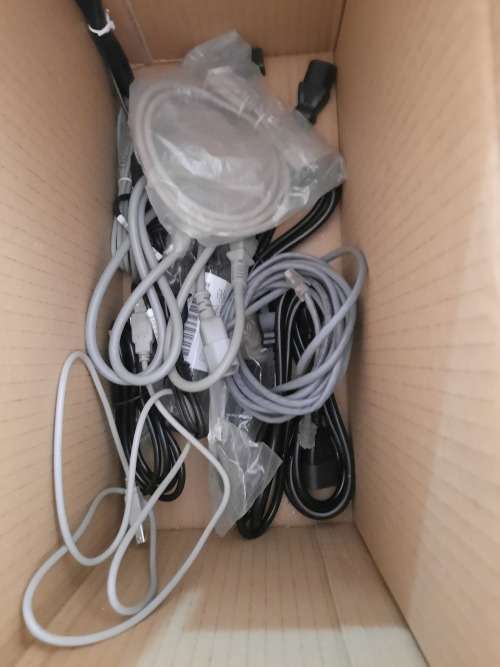 Box of computer cables and programme discs