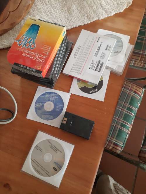 Box of computer cables and programme discs