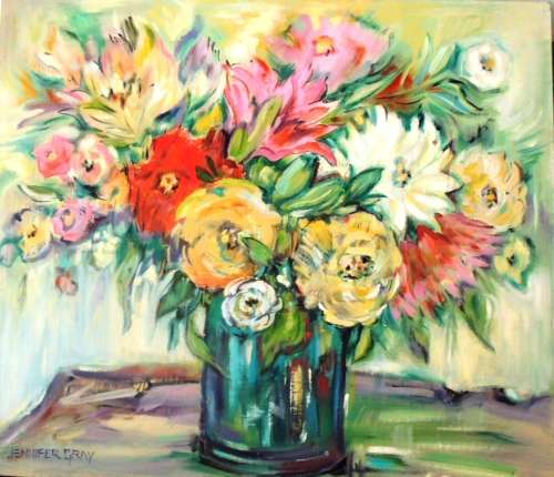 Bottle green vase with mixed flowers.