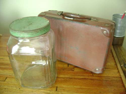 old bottle with tin lid and small suitcase