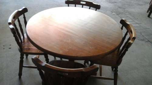 IT MIGHT BE PINE BUT IT IS A BEAUTIFUL SOLID DARK STAINED AND VARNISHED ROUND TABLE AND FOUR CHAIRS