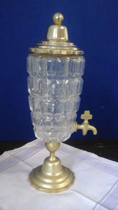 DEFINITLY DIFFERENT. A POSSIBLY CUT GLASS AND BRASS DECANTER. BRASS LID BASE AND EVEN A BRASS TAP