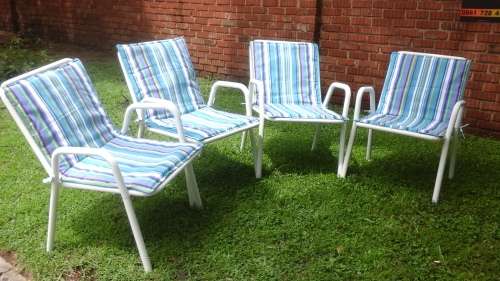 FOUR ABSOLUTELY STUNNING SLATTED STEEL GARDEN CHAIRS. THE BRAND NEW CUSHIONS FINNISH THE PICTURE