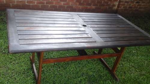 A FANTASTIC RECTANGULAR WOODEN PATIO TABLE. EVEN HAS PLACE TO PUT YOUR UMBRELLA