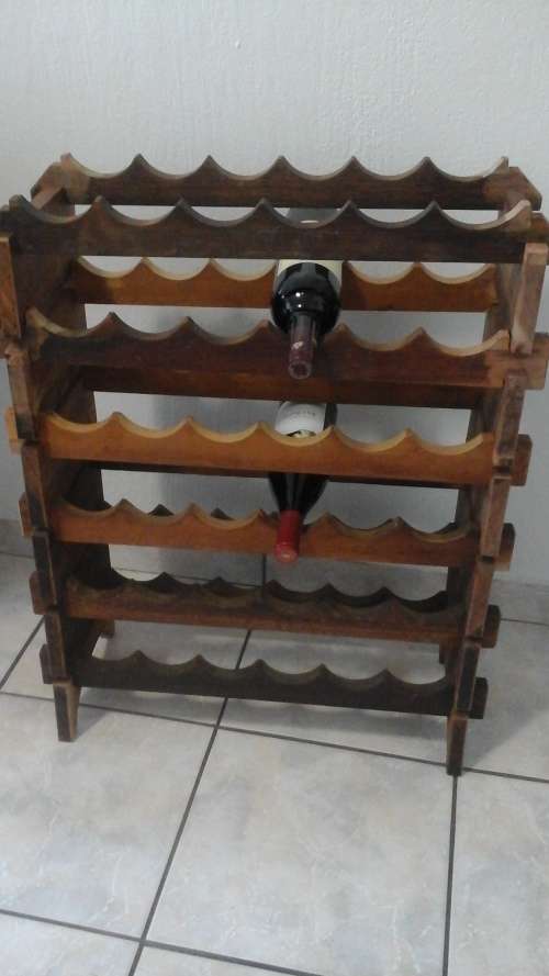 A STUNNING WOODEN WINE RACK MADE POSSIBLY FROM KIAAT. TAKES 36 BOTTLES