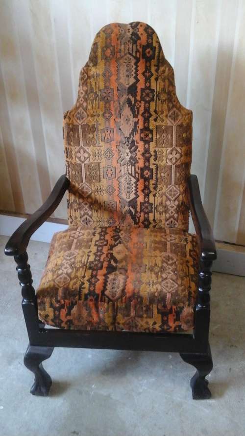 A RIGID VINTAGE IMBUIA CARVER/ARMCHAIR. COVERED IN AUTUMN COLOURED FABRIC. MAJESTIC PIECE