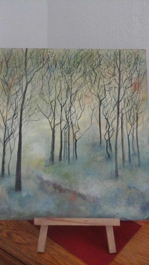 AN UNSIGNED UNFRAMED PAINTING OF TREES IN A FOREST LOOKS LIKE WINTER AS THERE ARE NO LEAVES