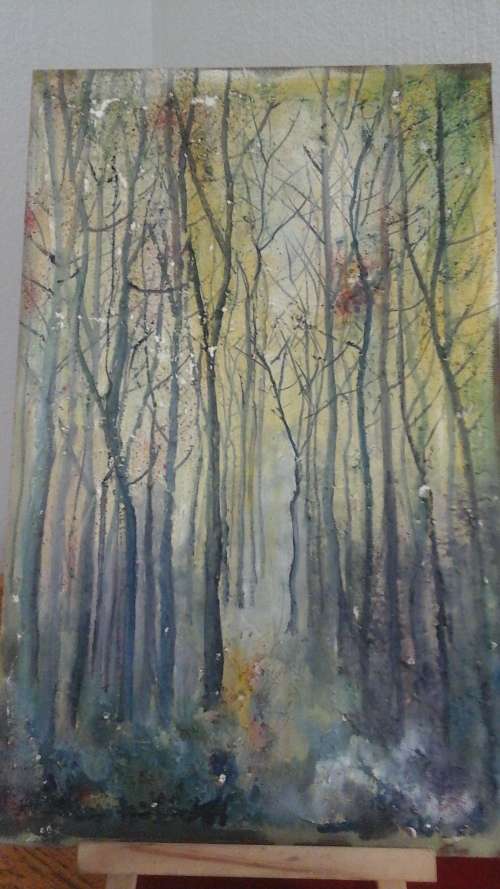 AN UNSIGNED UNFRAMED PAINTING OF TREES IN A FOREST LOOKS LIKE WINTER AS THERE ARE NO LEAVES