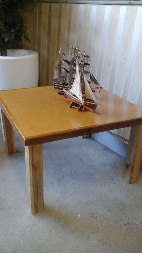 UNUSUAL YET APPEALING TO THE EYE. A COFFEE TABLE WITH A POSSIBLY SUPERWOOD TOP AND PINE SQUARE LEGS