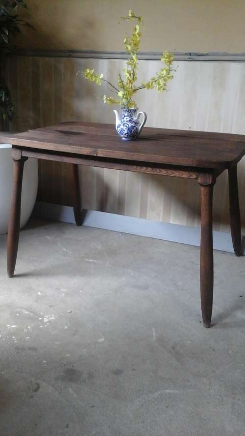 OVER 100 YEAR OLD POSSIBLY OAK KITCHEN TABLE. WARPED WITH AGE AND LOTS OF CHARACTER