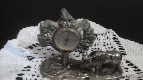 A MARVELLOUS PLATED ORNAMENT OF A BEAST AND A TREE. THE TREE IS HOLDING  A THERMOMETRE. MAGNIFICENT