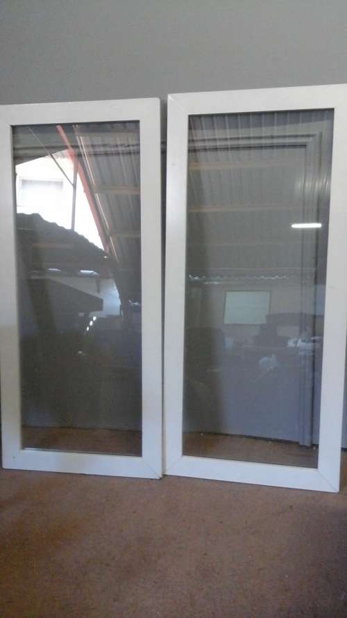 TWO MAGNIFICENT WOOD FRAMED GLASS DOORS. CAN MAKE THEM SLIDE OR PUT HINGES ON