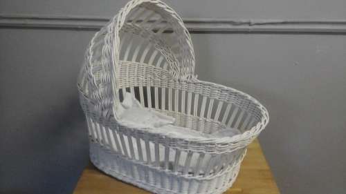 A LOVELY STURDY VINTAGE WICKER DOLLS CRIB. HAS ITS OWN LINEN WHICH IS NEW. MAKE A LITTLE GIRL HAPPY