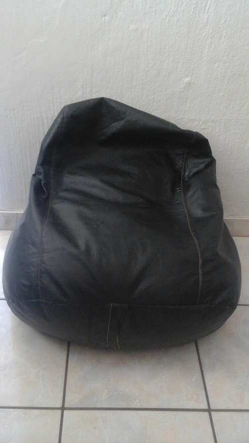 A FANTASTIC LITTLE BEAN BAG IN THE SHAPE OF AN ARMCHAIR. MADE FROM FAUX LEATHER VERY LIFELIKE