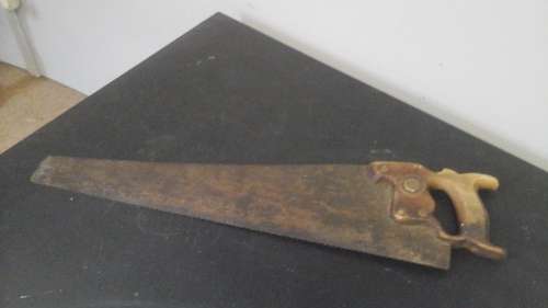 USEABLE AND COLLECTIBLE A VINTAGE SAW. THE BLADE IS STEEL AND THE HANDLE IS WOOD
