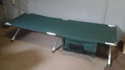 A FANTASTIC FOLD UP LIGHTWEIGHT ALUMINIUM STRETCHER/ CAMP BED.  FOLDS UP AND CAN BE PACKED AWAY
