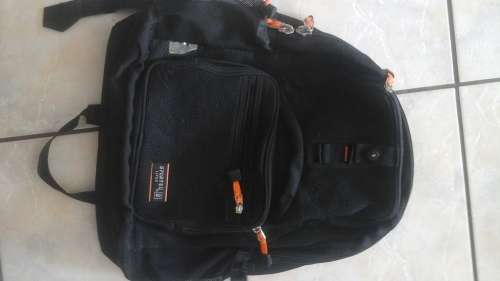A HANDY BLACK AND ORANGE BACKPACK. PERFECT FOR TRAVEL NICE AND LIGHT