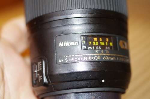 Nikon 60mm 2.8. this lens has signs of use as shown itn the photos, works 100%,