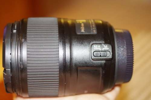 Nikon 60mm 2.8. this lens has signs of use as shown itn the photos, works 100%,