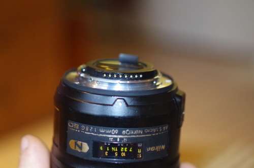 Nikon 60mm 2.8. this lens has signs of use as shown itn the photos, works 100%,