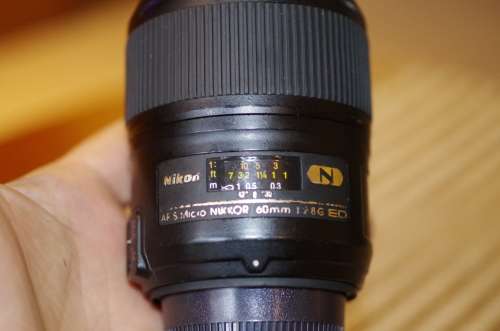 Nikon 60mm 2.8. this lens has signs of use as shown itn the photos, works 100%,