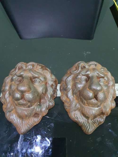 TWO SOLID CAST IRON LION HEADS....HEAVY METAL