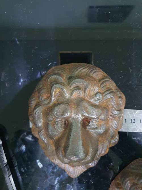 TWO SOLID CAST IRON LION HEADS....HEAVY METAL
