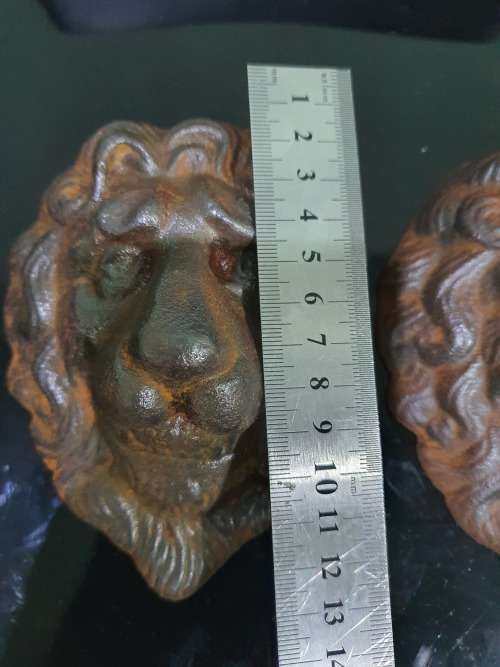 TWO SOLID CAST IRON LION HEADS....HEAVY METAL